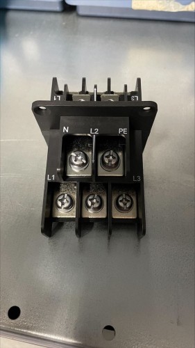 Black plastic connector with metal screws of irregular shape